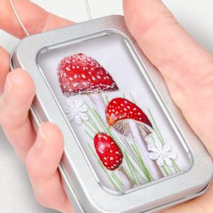fabric picture of toadstools in a tin